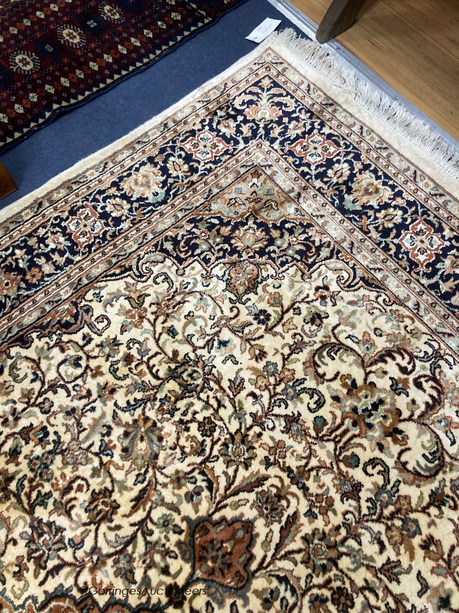 An ivory ground Kashmiri rug, 184 x 124cm